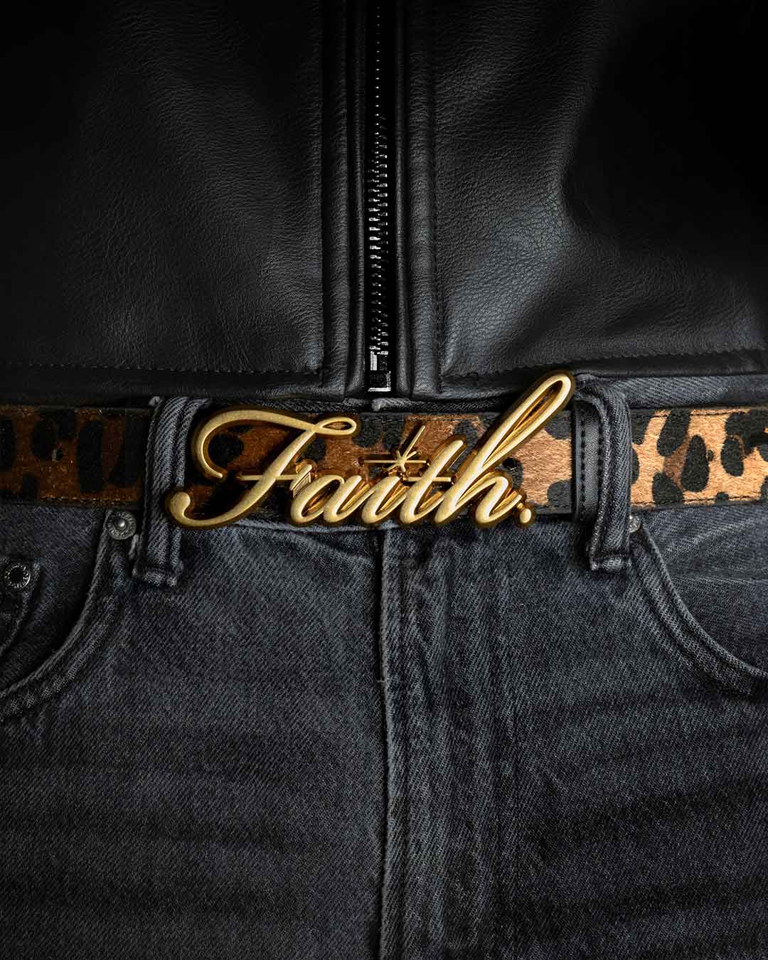 Leopard faux belt with a bold gold 'Faith' buckle, styled with black denim jeans and a black leather jacket